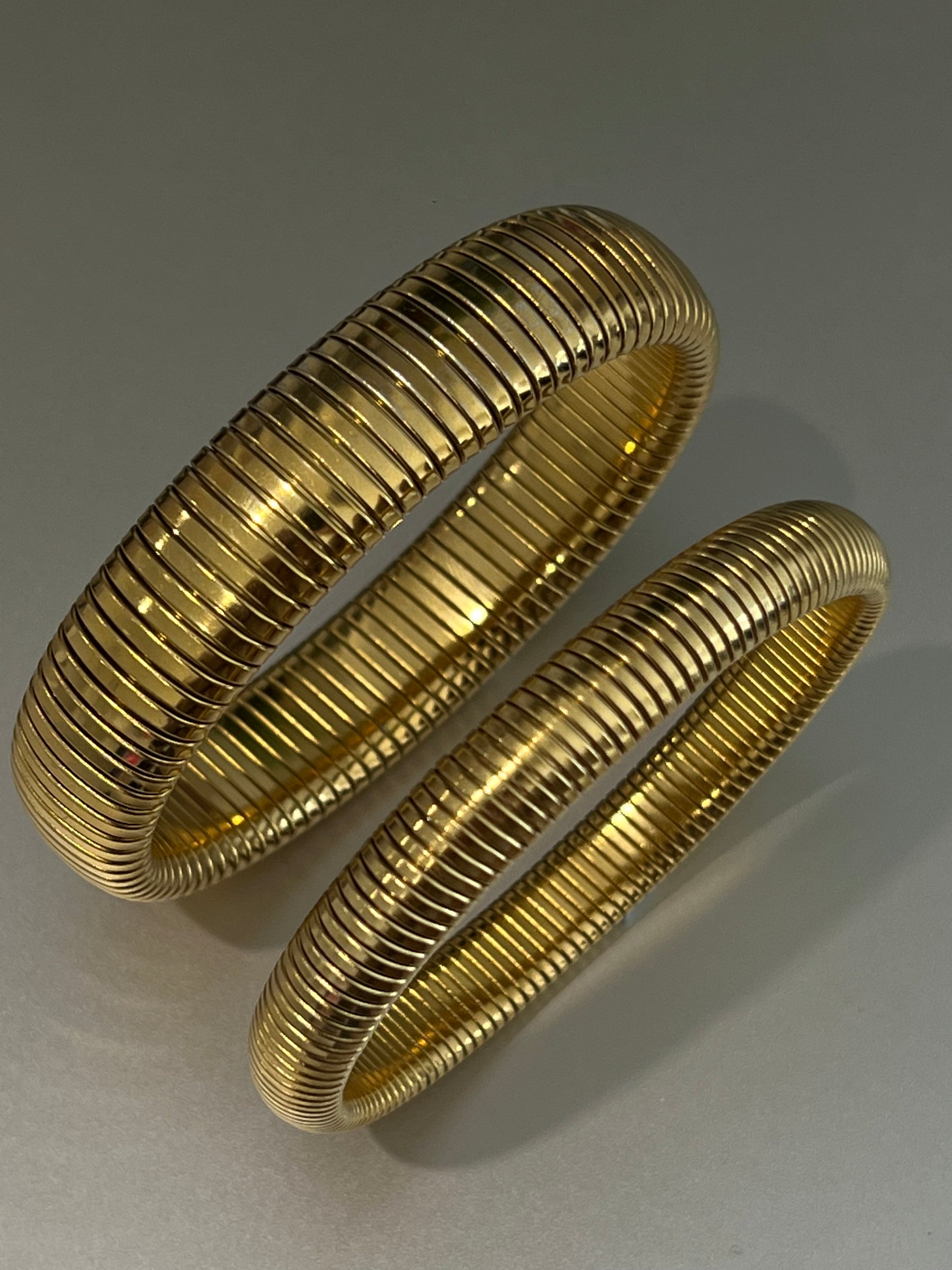 Close-up of wide and slim waterproof gold cuffs with ridged texture | Ember Cuff by EverLuxe