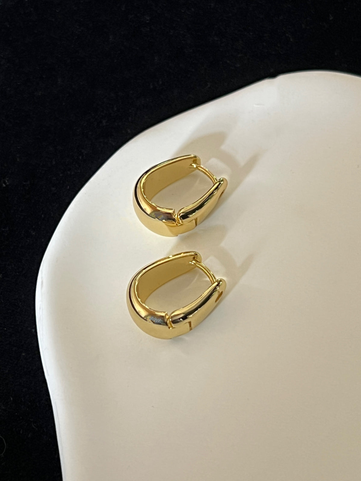 Smooth curved gold statement hoops waterproof tarnish resistant and hypoallergenic 
