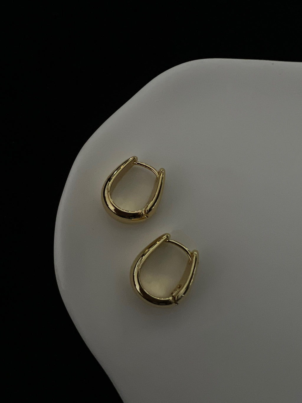 Liora chunky gold oval earrings close-up