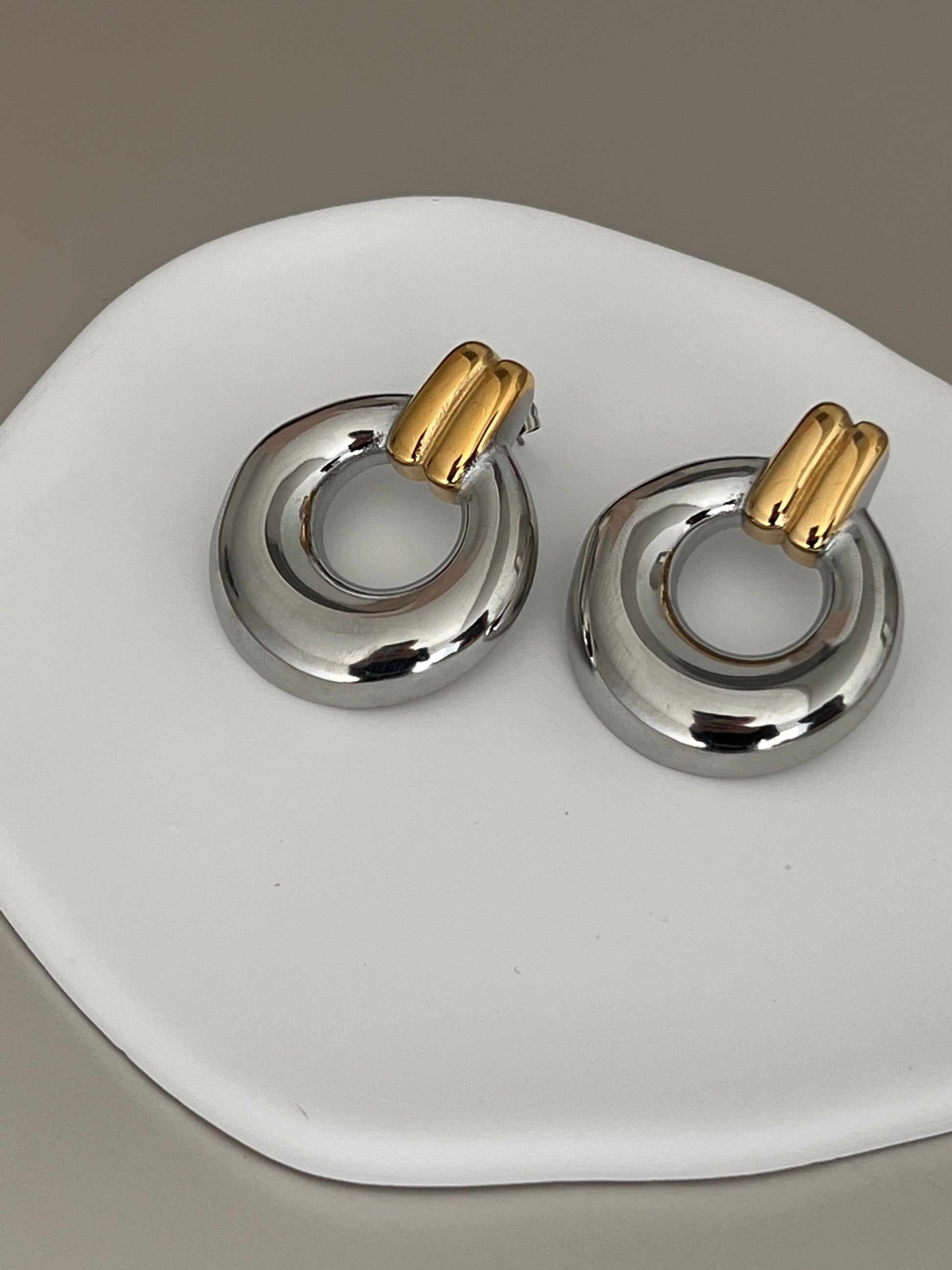 Solara Drop silver and gold earrings on white plate – EverLuxe