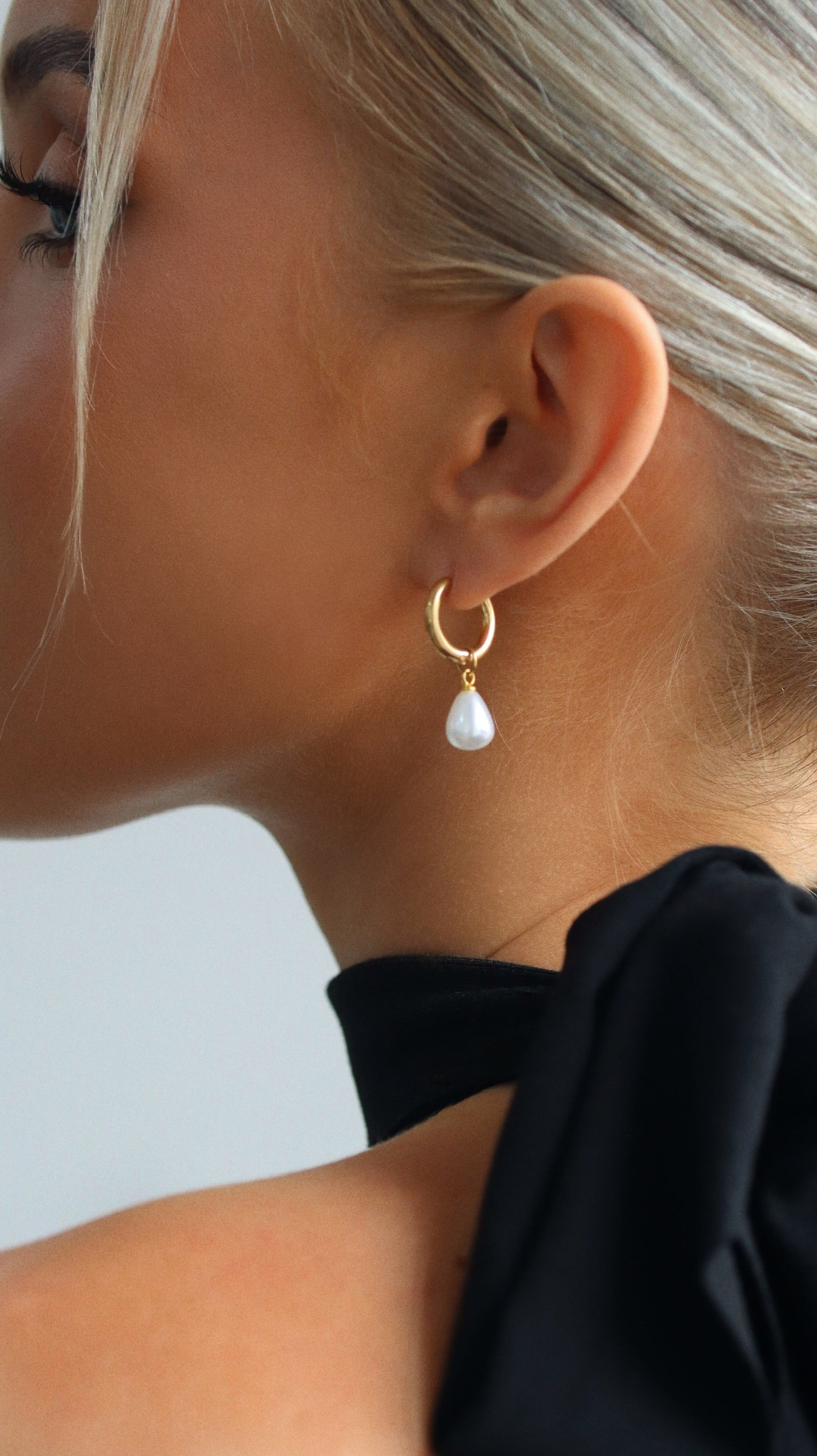 Model wearing Luna Drop gold earrings – delicate and elegant